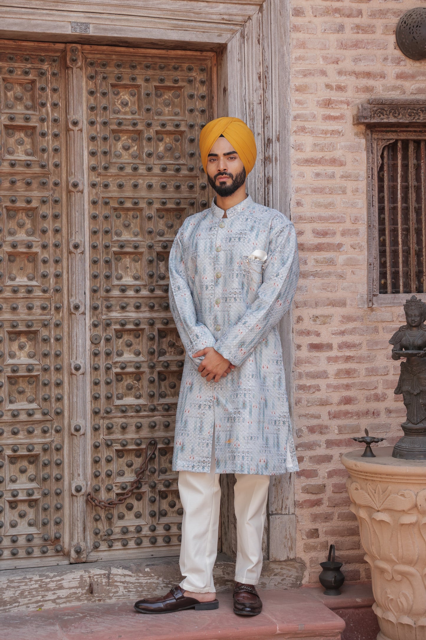 Men's light blue kurta with patterns paired with white churidar, mandarin collar, side pockets, full sleeves - premium Indian formal wear for weddings and special occasion