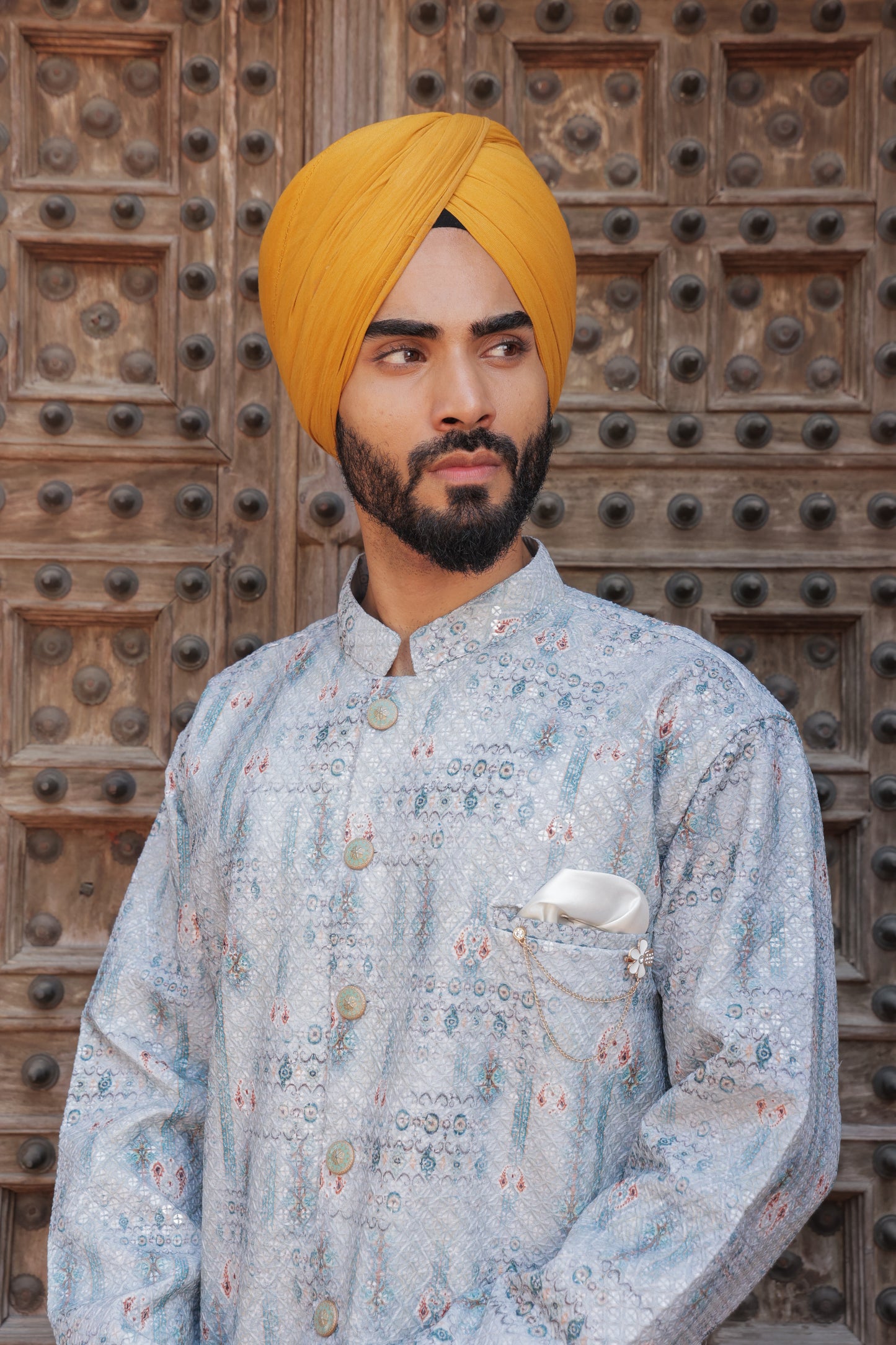 Men's light blue kurta with patterns paired with white churidar, mandarin collar, side pockets, full sleeves - premium Indian formal wear for weddings and special occasion