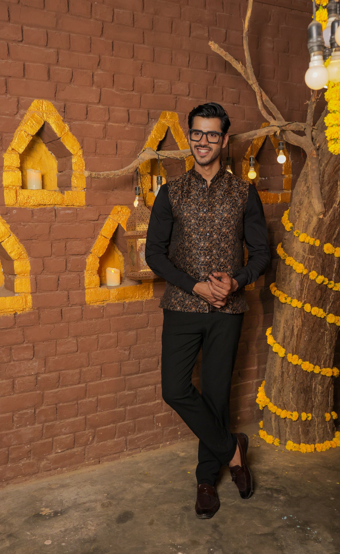 Men's black Nehru or Modi jacket vest with intricate golden botanical print, worn over dress shirt - traditional Indian formal wear