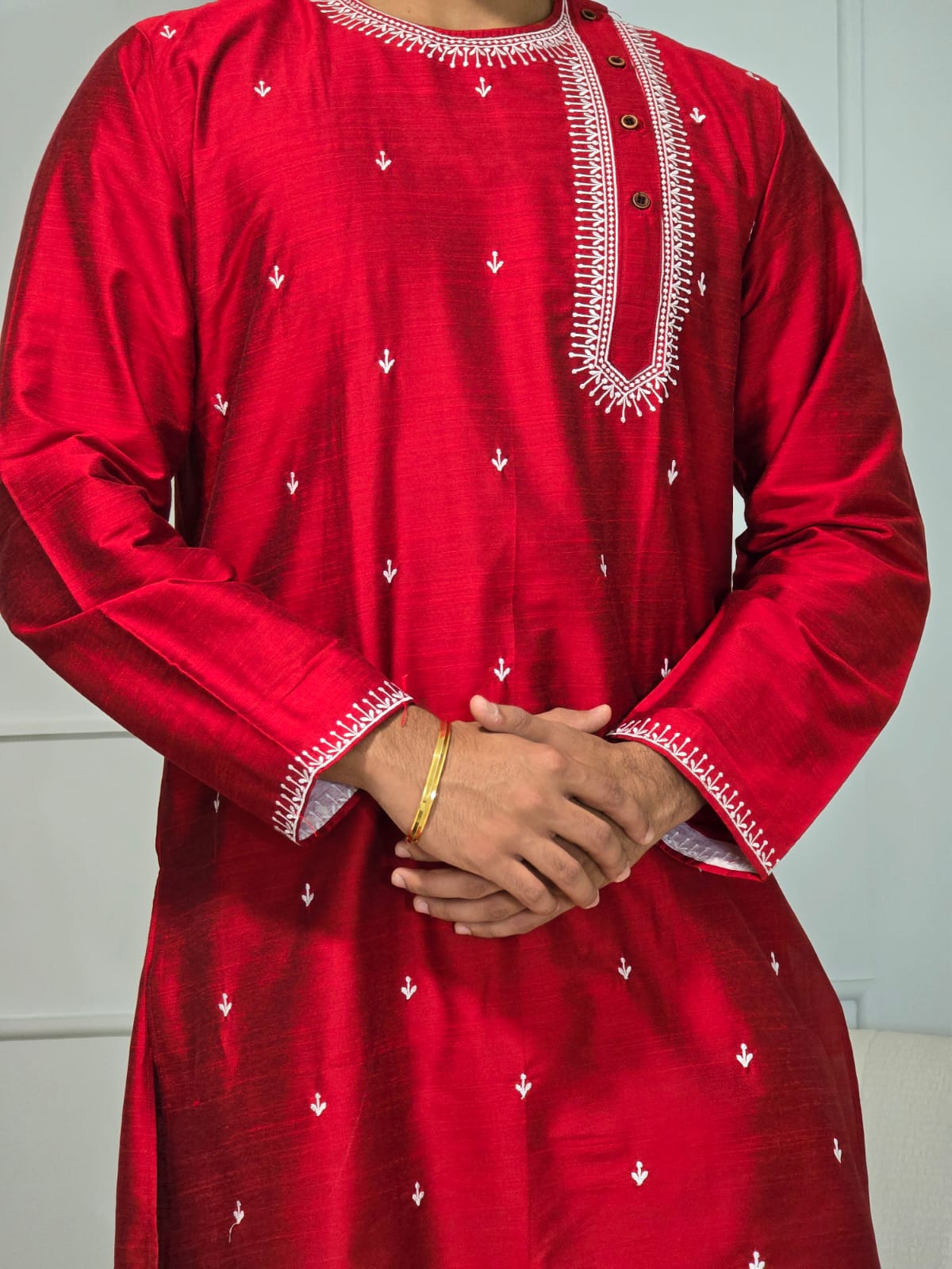 Men's red kurta with white thread embroidered around neck and cuffs, side pockets, full sleeves with side closure - traditional Indian wear for social occasions and festivals