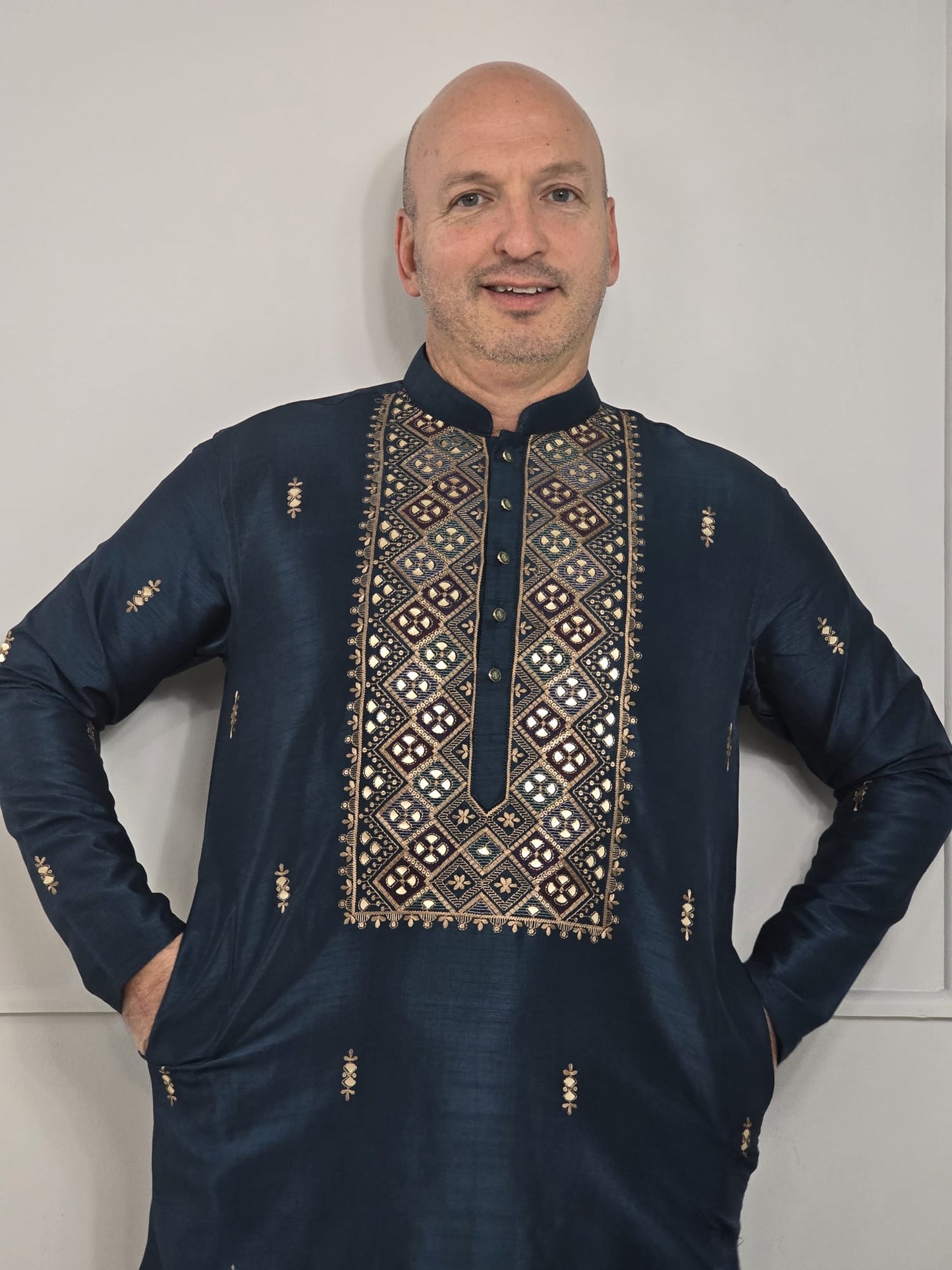 Men's blue kurta with embroidered neckline paired with white churidar, mandarin collar, side pockets, full sleeves - premium Indian formal wear for weddings and special occasions