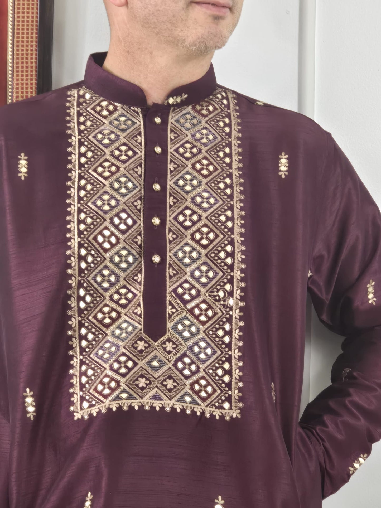 Men's maroon kurta with embroidered neckline paired with white churidar, mandarin collar, side pockets, full sleeves - premium Indian formal wear for weddings and special occasions