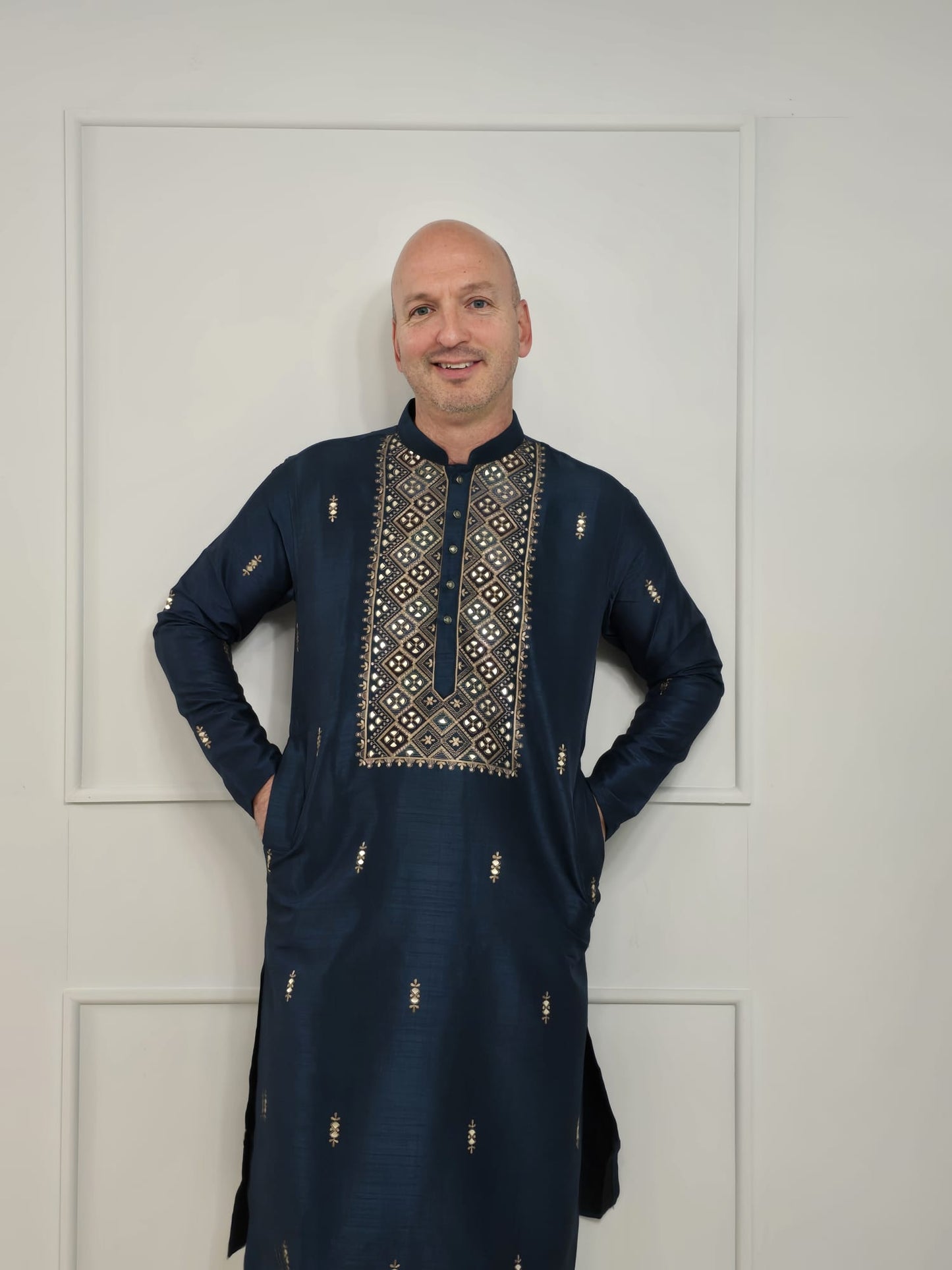 Men's blue kurta with embroidered neckline paired with white churidar, mandarin collar, side pockets, full sleeves - premium Indian formal wear for weddings and special occasions