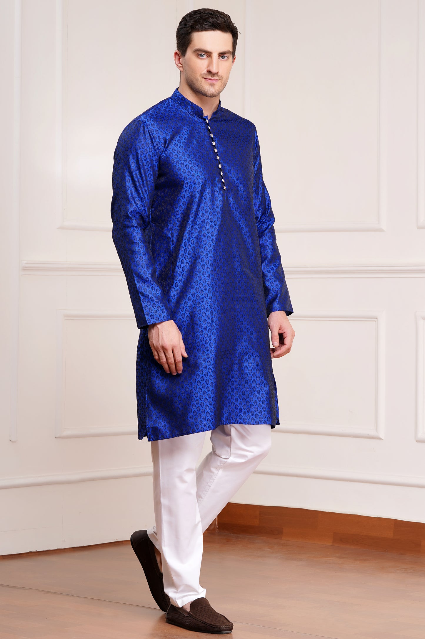 Men's bright blue silk kurta with gold brocade diamond pattern and white churidar pants, decorative buttons with loop closure, mandarin collar, full sleeves, side pockets - traditional Indian festive wear