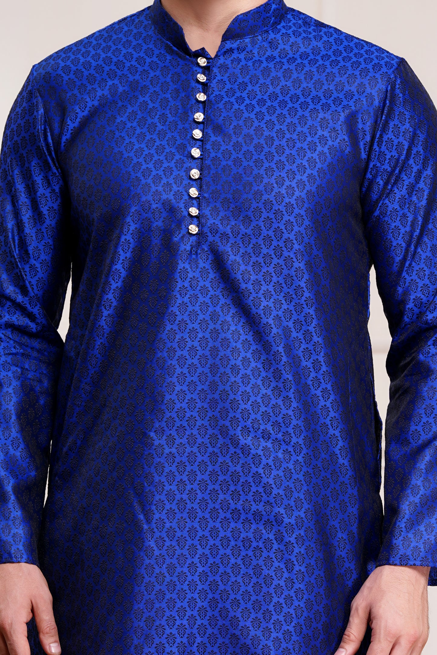 Men's bright blue silk kurta with gold brocade diamond pattern and white churidar pants, decorative buttons with loop closure, mandarin collar, full sleeves, side pockets - traditional Indian festive wear