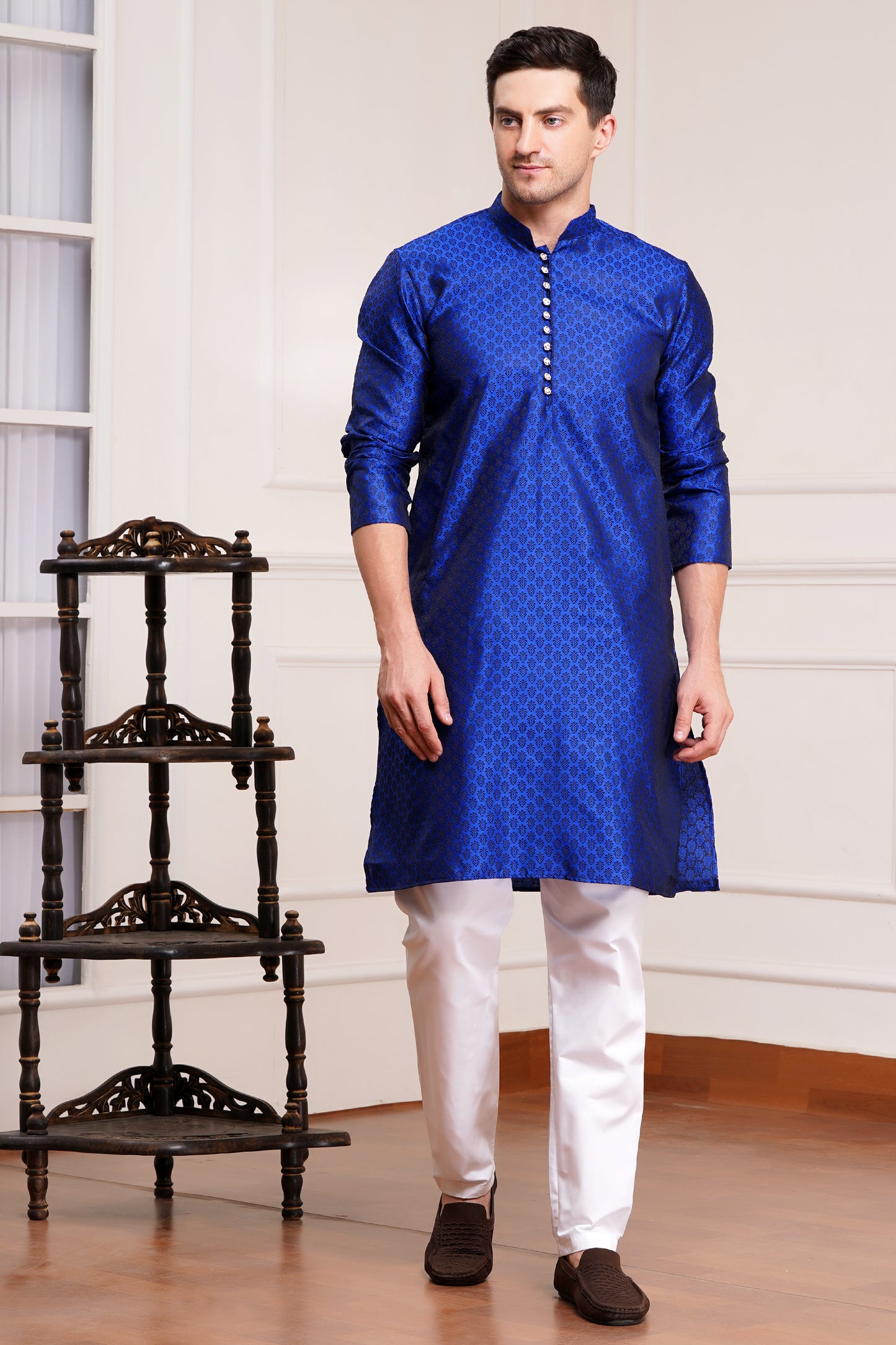 Men's bright blue silk kurta with gold brocade diamond pattern and white churidar pants, decorative buttons with loop closure, mandarin collar, full sleeves, side pockets - traditional Indian festive wear