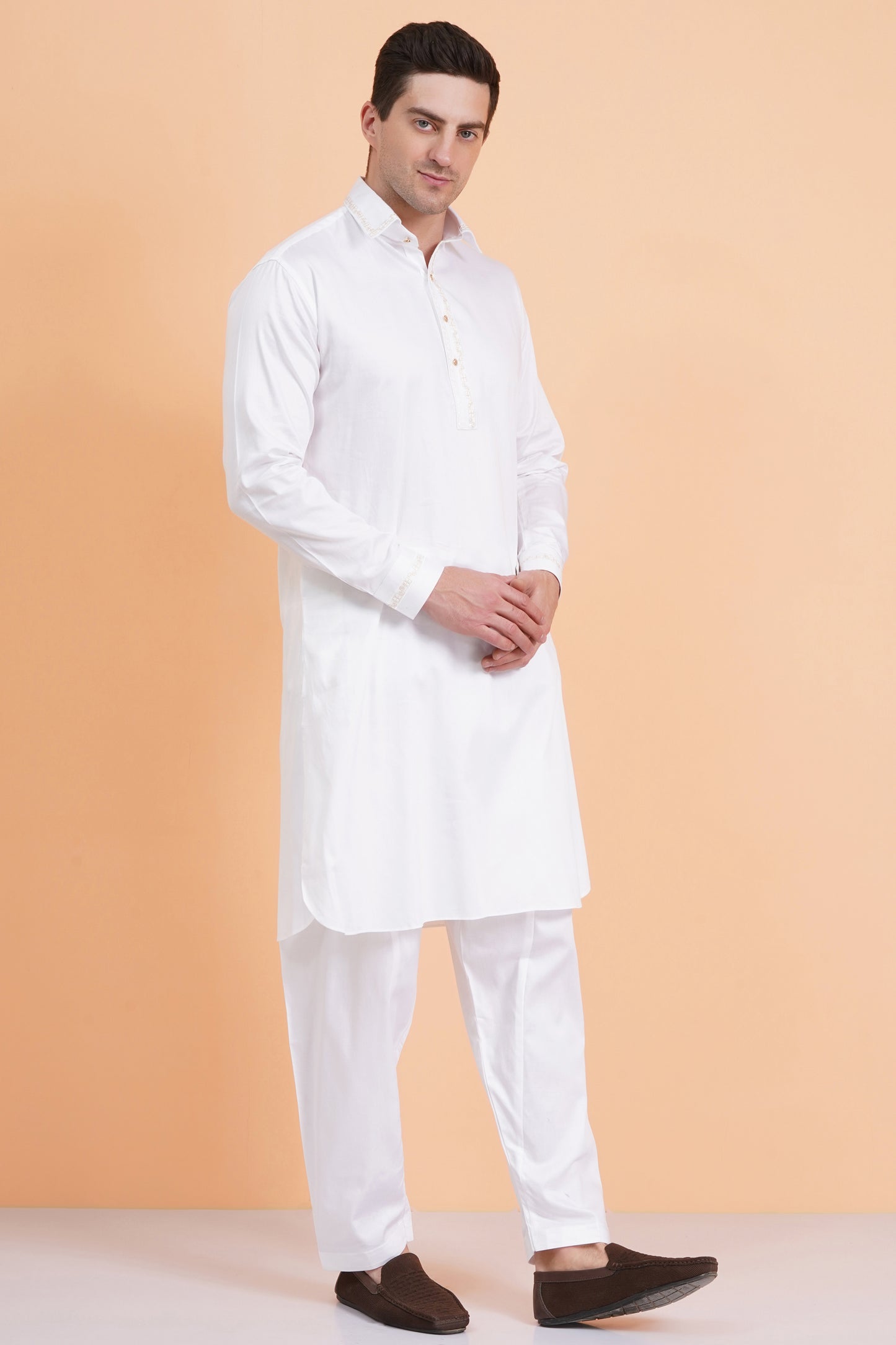 Men white Pathani suit set with knee-length kurta and matching trousers, embroidery around placket and cuffs, shirt collar, button closure, front and side pockets, full sleeves with cuff button closure - traditional casual and festive ethnic wear