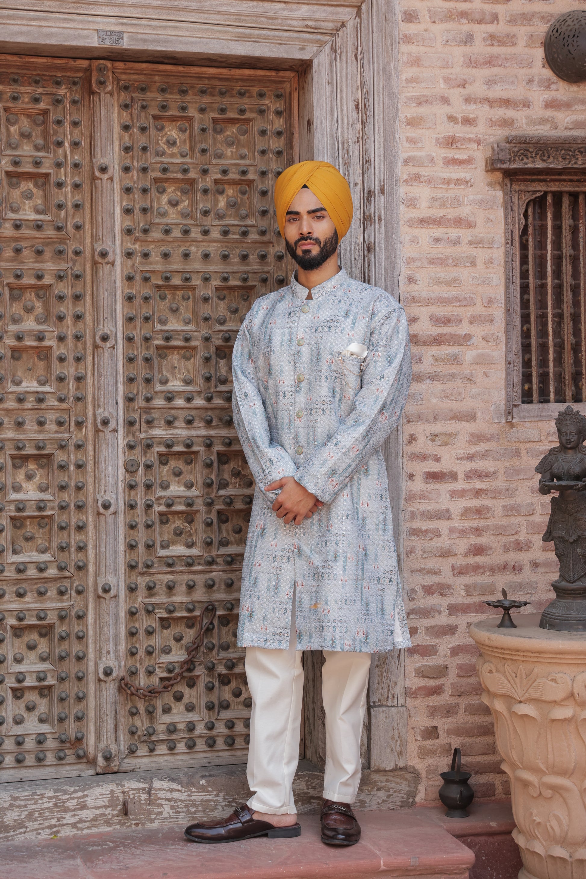 Men's light blue kurta with patterns paired with white churidar, mandarin collar, side pockets, full sleeves - premium Indian formal wear for weddings and special occasion