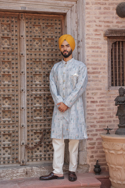 Men's light blue kurta with patterns paired with white churidar, mandarin collar, side pockets, full sleeves - premium Indian formal wear for weddings and special occasion