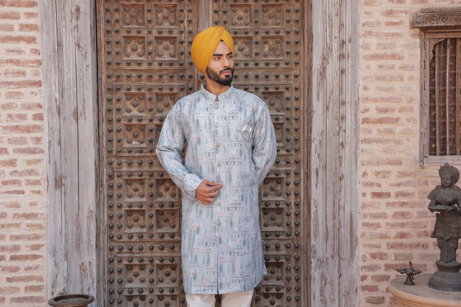 Men's light blue kurta with patterns paired with white churidar, mandarin collar, side pockets, full sleeves - premium Indian formal wear for weddings and special occasion