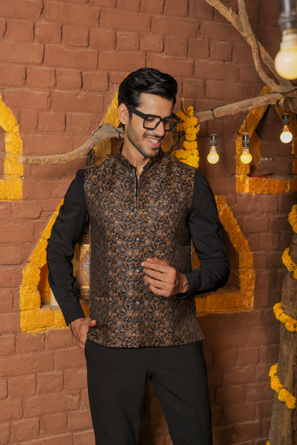 Men's black Nehru or Modi jacket vest with intricate golden botanical print, worn over dress shirt - traditional Indian formal wear