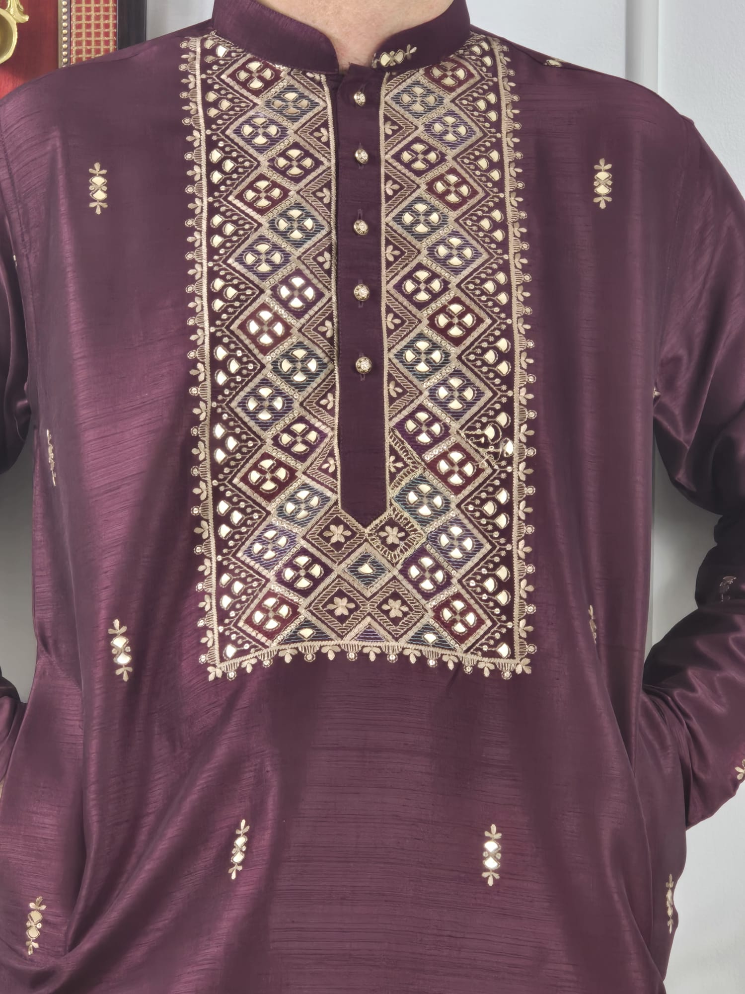 Men's maroon kurta with embroidered neckline paired with white churidar, mandarin collar, side pockets, full sleeves - premium Indian formal wear for weddings and special occasions