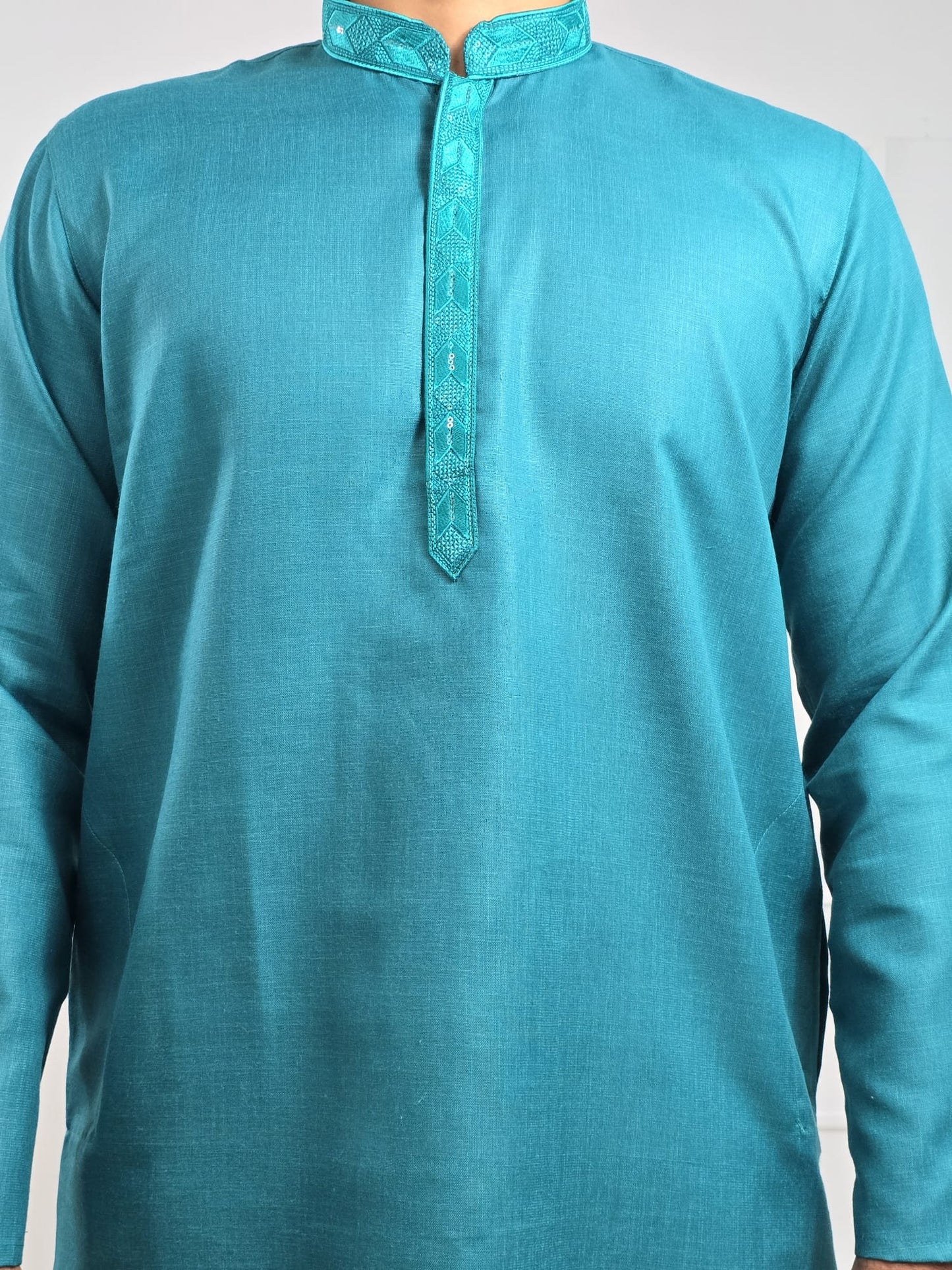 Men's blue kurta with embroidered neckline paired with white churidar, mandarin collar, side pockets, full sleeves - premium Indian formal wear for weddings and special occasions