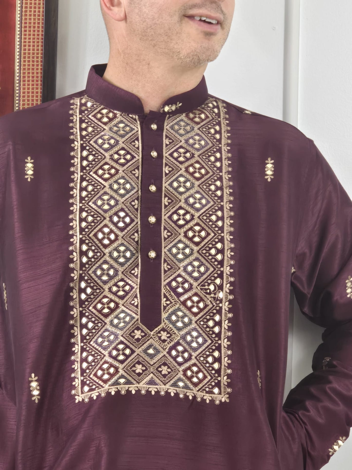Men's maroon kurta with embroidered neckline paired with white churidar, mandarin collar, side pockets, full sleeves - premium Indian formal wear for weddings and special occasions