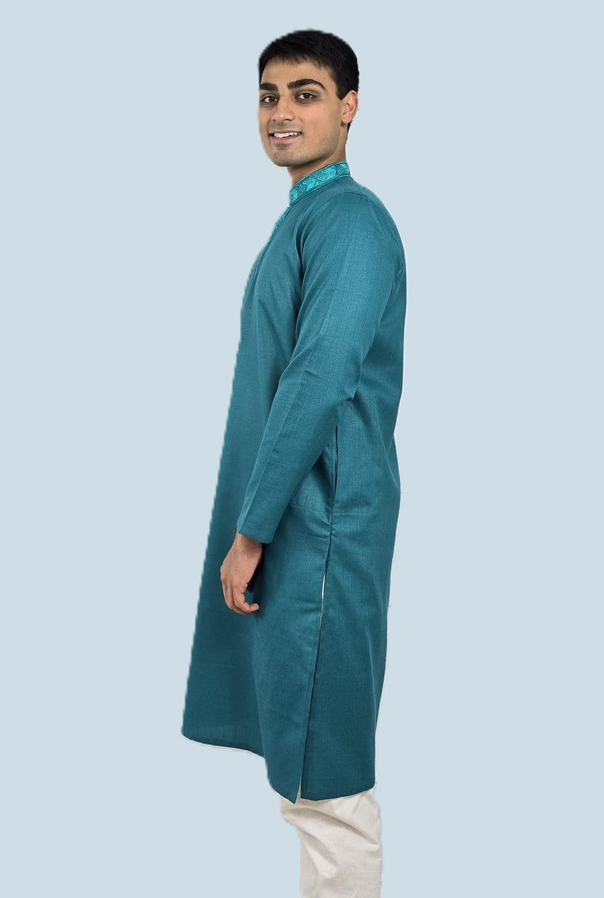 Men's blue kurta with embroidered neckline paired with white churidar, mandarin collar, side pockets, full sleeves - premium Indian formal wear for weddings and special occasions