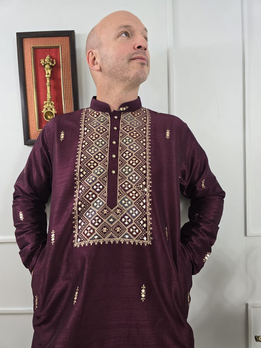 Men's maroon kurta with embroidered neckline paired with white churidar, mandarin collar, side pockets, full sleeves - premium Indian formal wear for weddings and special occasions