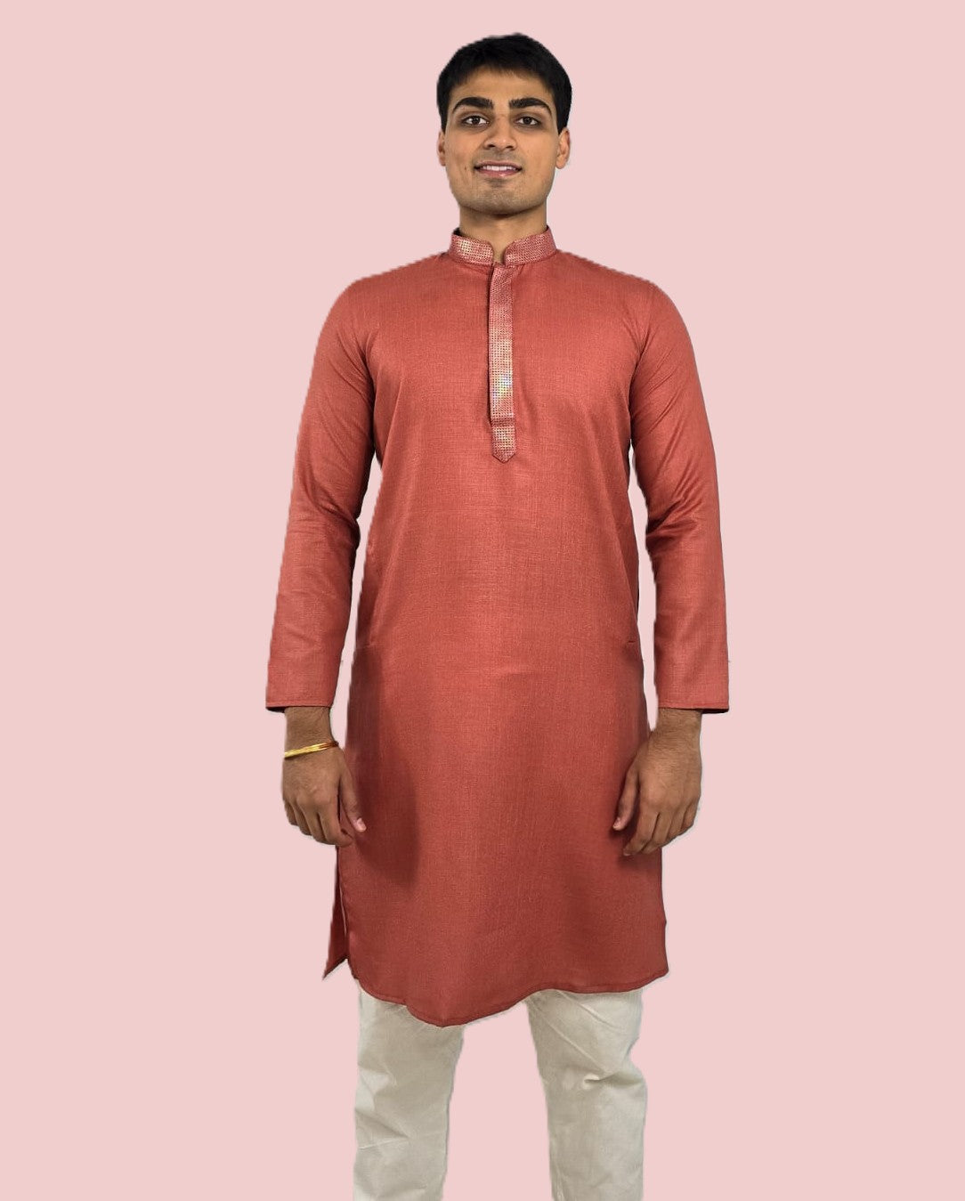 Men's rust or deep carrot color kurta with embroidered neckline paired with white churidar, mandarin collar, side pockets, full sleeves - premium Indian formal wear for weddings and special occasions