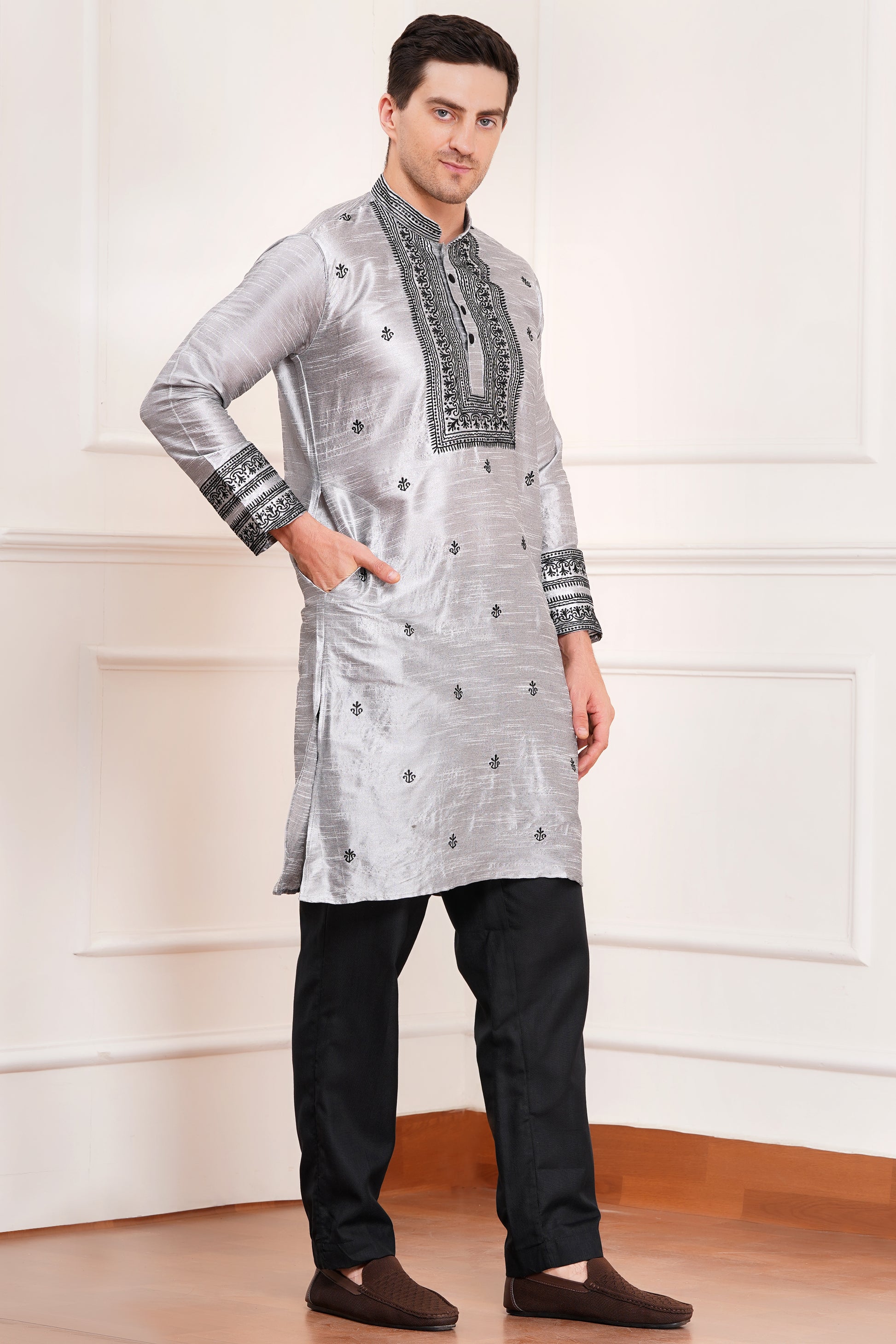 Men's gray silk kurta with black embroidered mandarin collar and cuffs, side pockets, full sleeves with black pants - traditional Indian formal wear for weddings and festivals