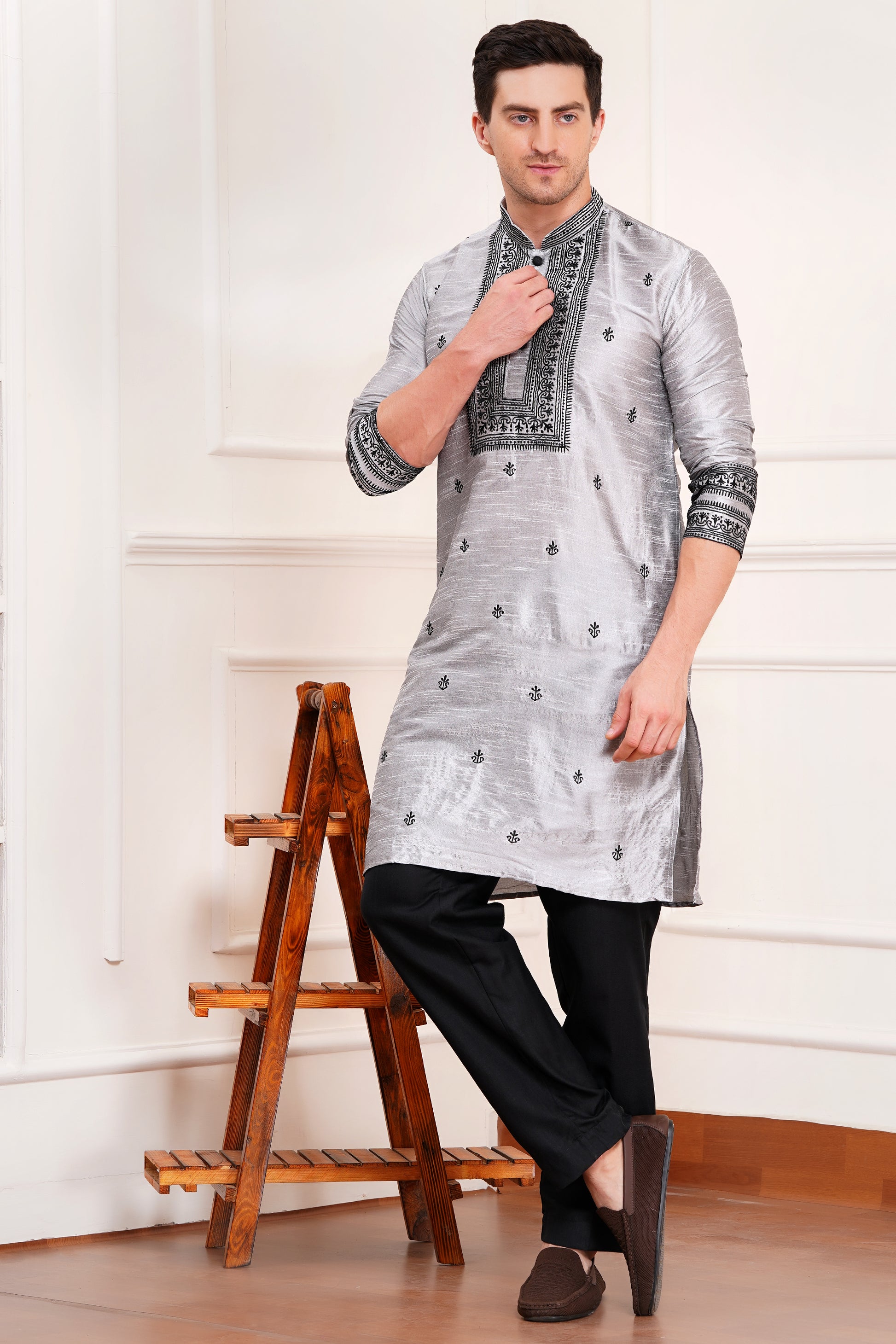 Men's gray silk kurta with black embroidered mandarin collar and cuffs, side pockets, full sleeves with black pants - traditional Indian formal wear for weddings and festivals