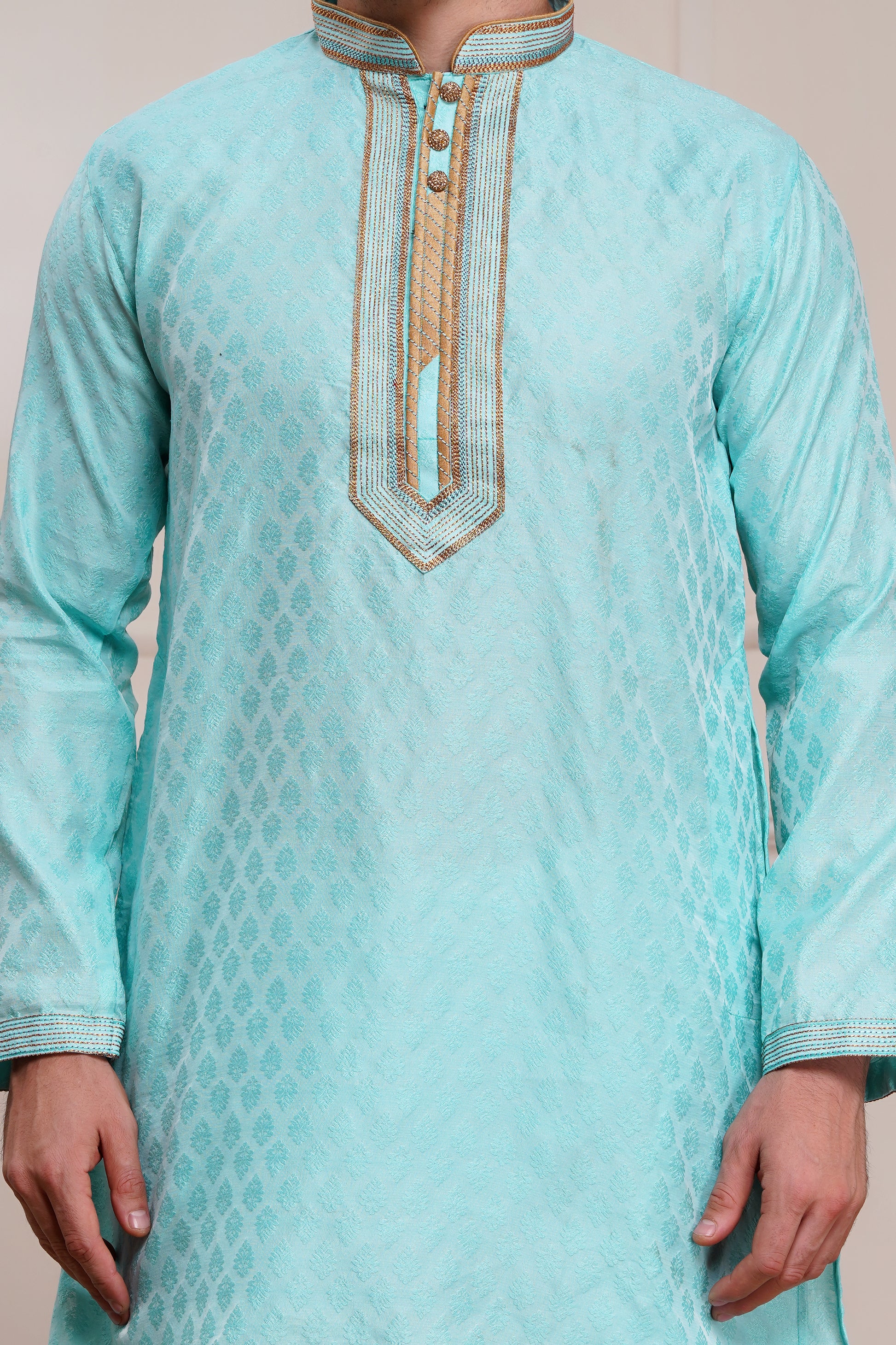 Men's light blue brocade kurta with gold embroidered neckline paired with white churidar, mandarin collar, side pockets, full sleeves - premium Indian formal wear for weddings and special occasions