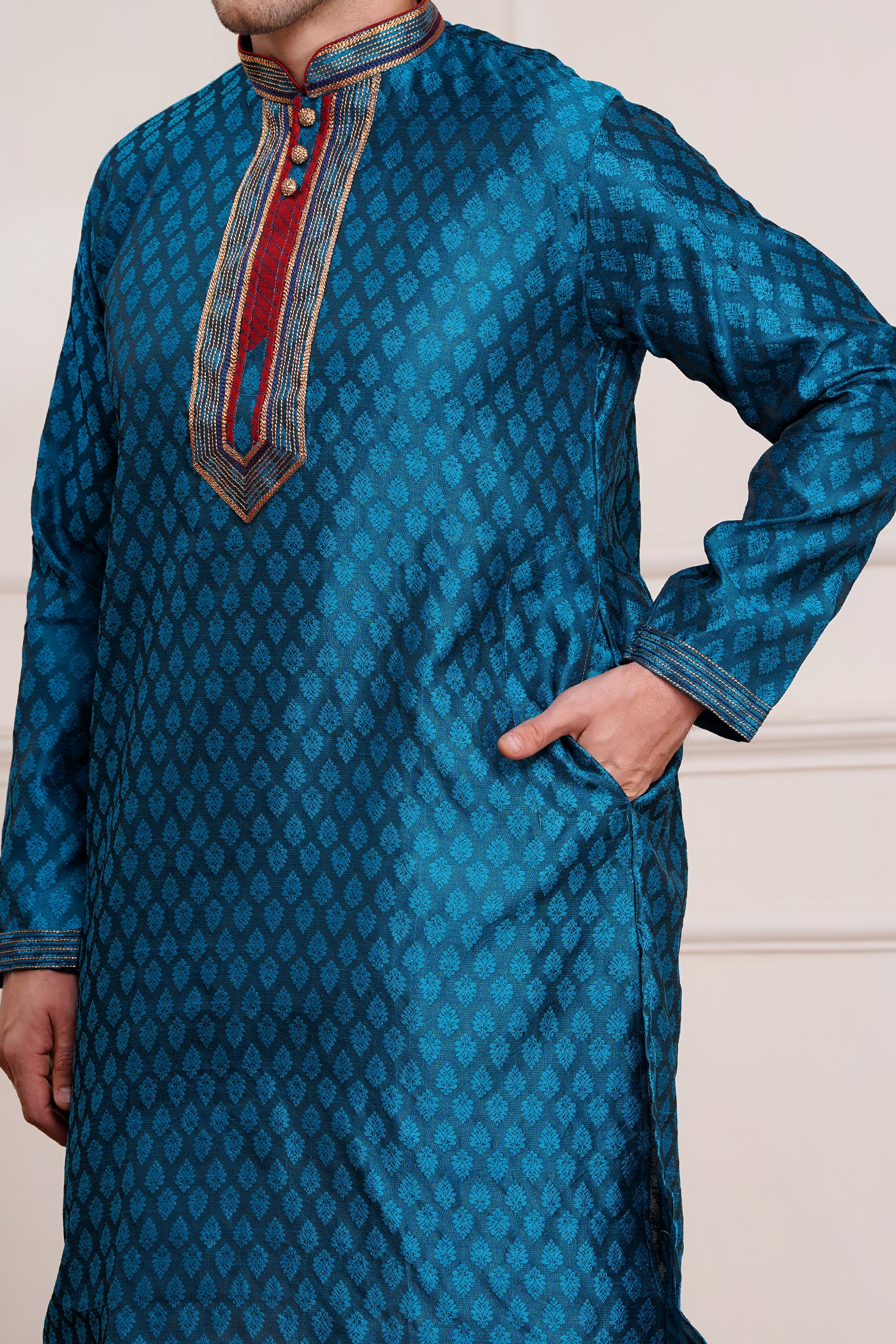Men's teal blue brocade kurta with red and gold embroidered neckline paired with white churidar, mandarin collar, side pockets, full sleeves - premium Indian formal wear for weddings and special occasions