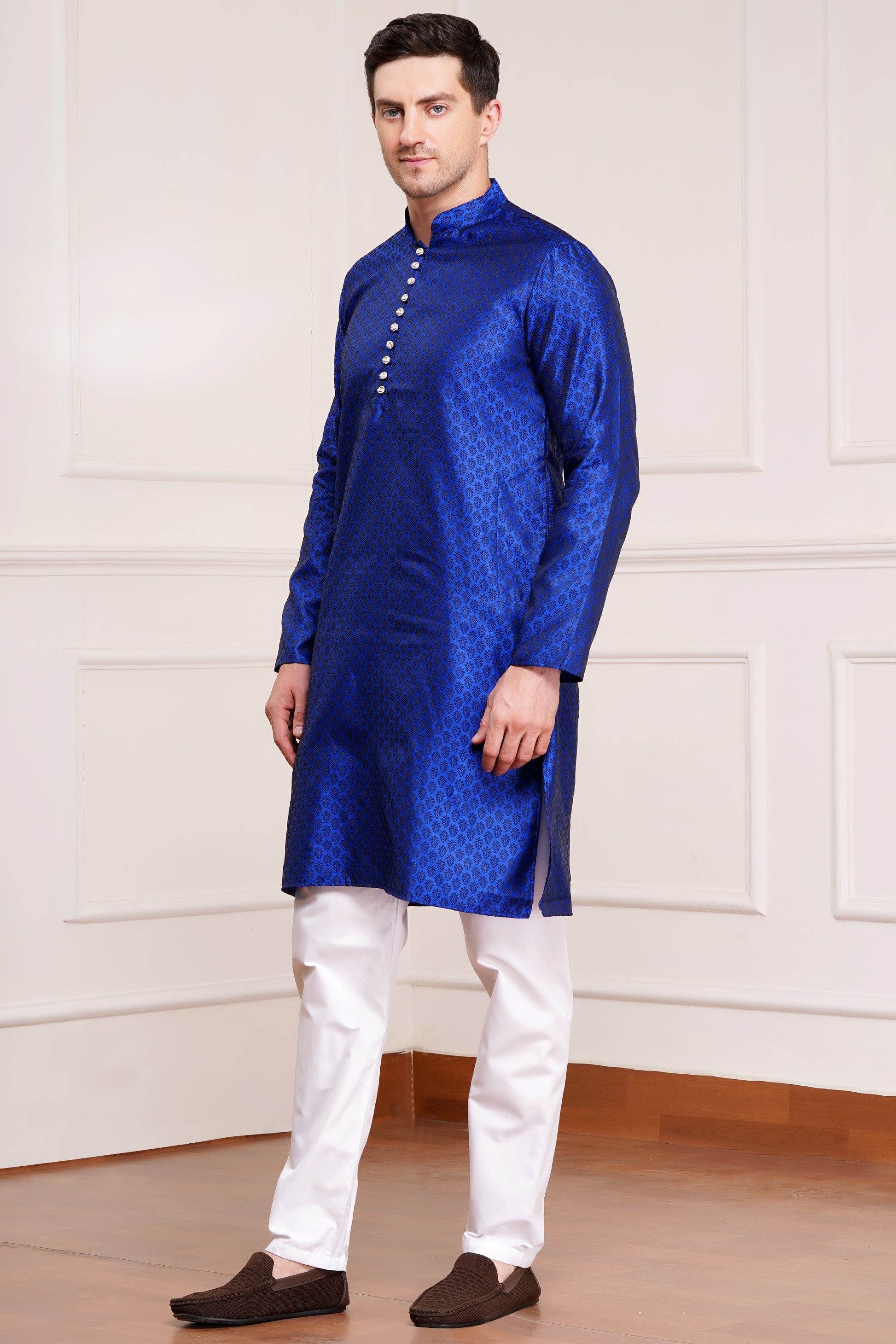 Men's bright blue silk kurta with gold brocade diamond pattern and white churidar pants, decorative buttons with loop closure, mandarin collar, full sleeves, side pockets - traditional Indian festive wear