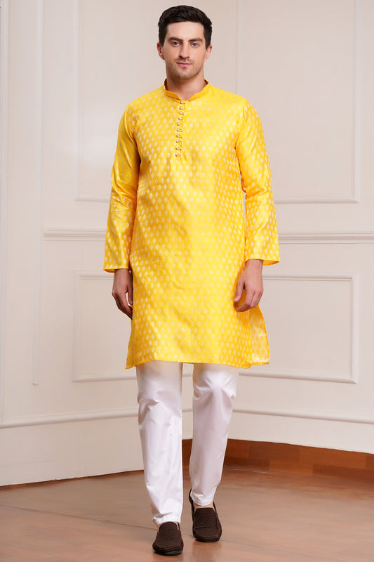 Men's bright yellow silk kurta with gold brocade diamond pattern and white churidar pants, decorative buttons with loop closure, mandarin collar, full sleeves - traditional Indian festive wear