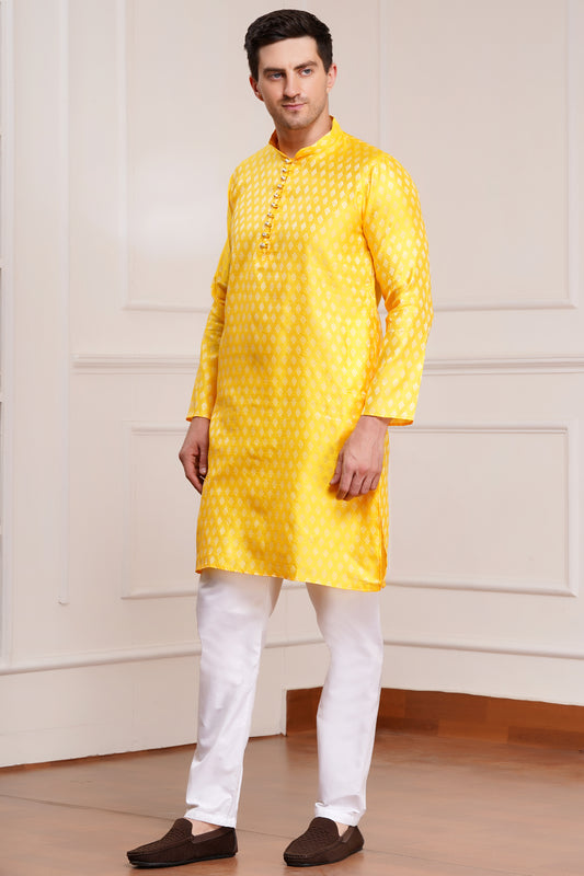 Men's bright yellow silk kurta with gold brocade diamond pattern and white churidar pants, decorative buttons with loop closure, mandarin collar, full sleeves - traditional Indian festive wear