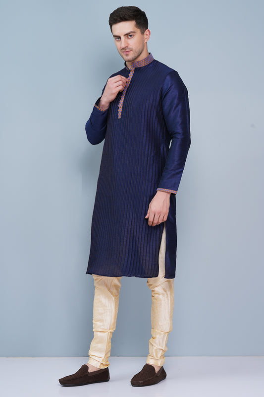 Men Navy Blue traditional Kurta with orange accent  on collar, placket and cuffs, full length, boondi button with loops closure, one fourth placket, full sleeves, mandarin collar, side pockets on Kurta with Off-white or cream color chudidar pajama. Perfect traditional wear for family special occasions, wedding, house warming, casual wear