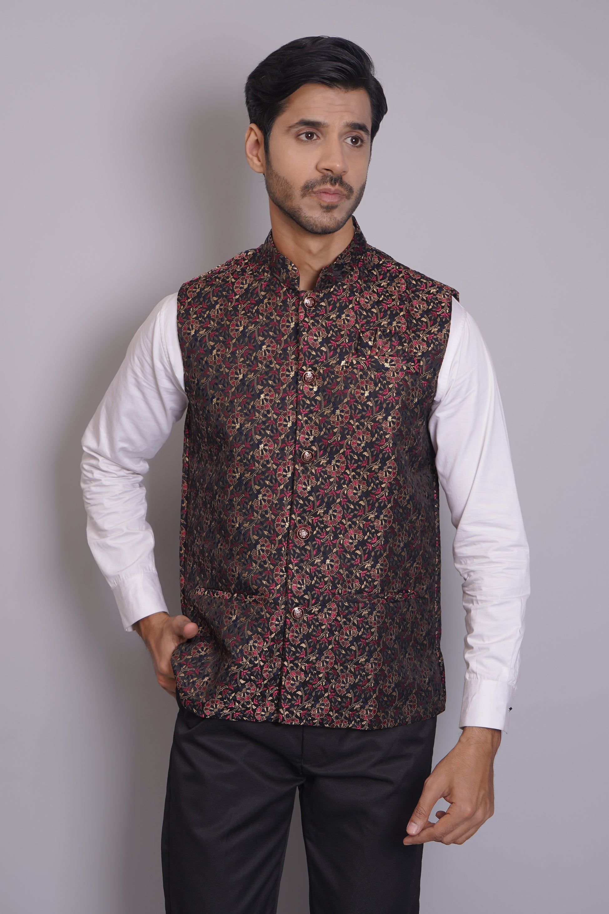 Men's dark floral patterned Nehru or Modi jacket vest with intricate red and gold botanical print, worn over dress shirt - traditional Indian formal wear
