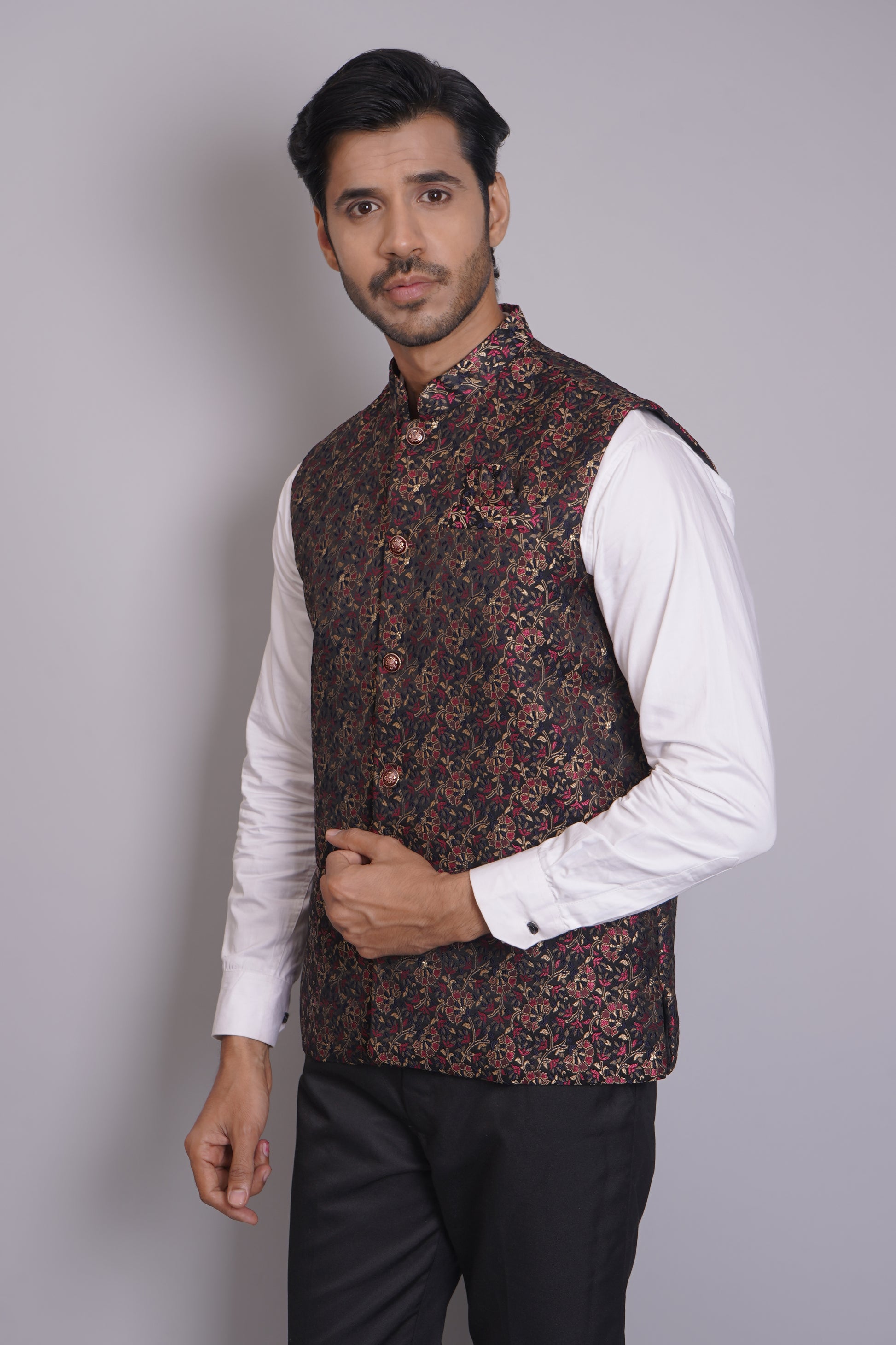 Men's dark floral patterned Nehru or Modi jacket vest with intricate red and gold botanical print, worn over dress shirt - traditional Indian formal wear