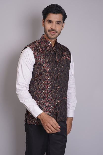 Men's dark floral patterned Nehru or Modi jacket vest with intricate red and gold botanical print, worn over dress shirt - traditional Indian formal wear