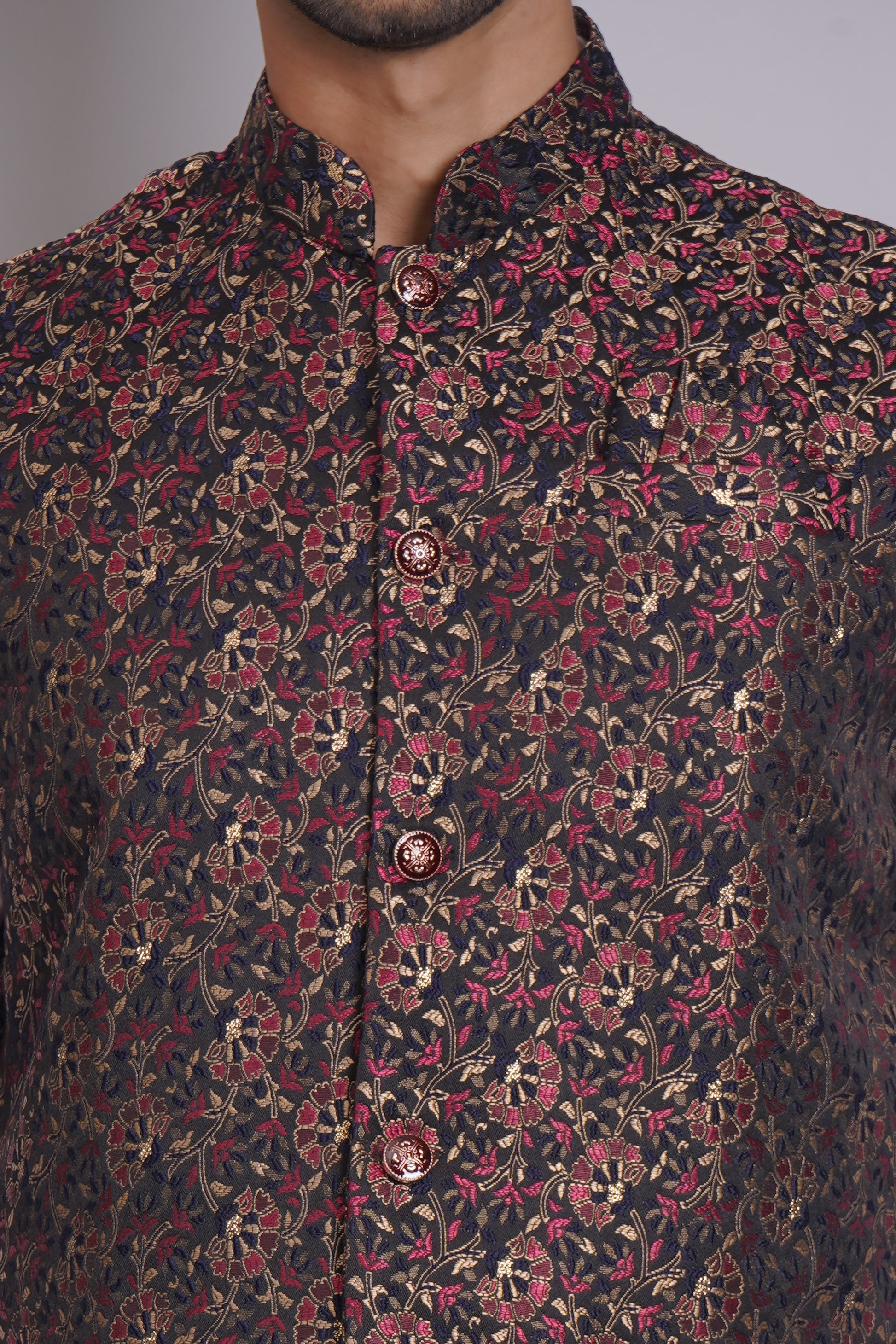 Men's dark floral patterned Nehru or Modi jacket vest with intricate red and gold botanical print, worn over dress shirt - traditional Indian formal wear