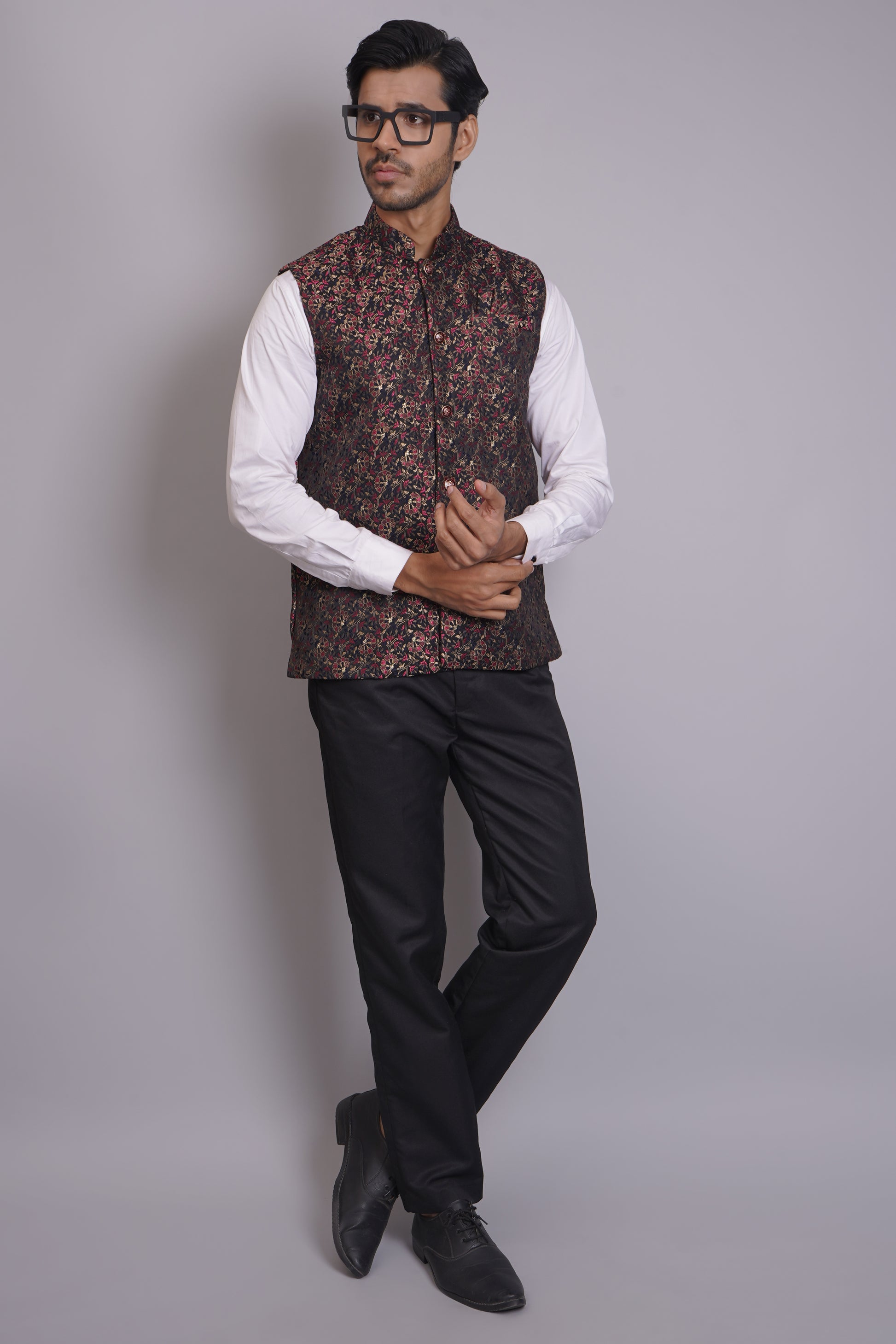 Men's dark floral patterned Nehru or Modi jacket vest with intricate red and gold botanical print, worn over dress shirt - traditional Indian formal wear