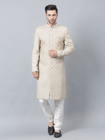 Men's light brown sherwani with intricate white embroidered geometric pattern, mandarin collar, and matching white churidar pants - ideal for special occasions and weddings
