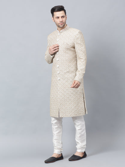 Men's light brown sherwani with intricate white embroidered geometric pattern, mandarin collar, and matching white churidar pants - ideal for special occasions and weddings