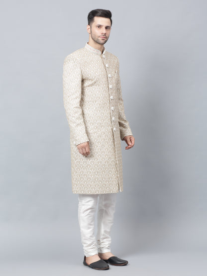 Men's light brown sherwani with intricate white embroidered geometric pattern, mandarin collar, and matching white churidar pants - ideal for special occasions and weddings