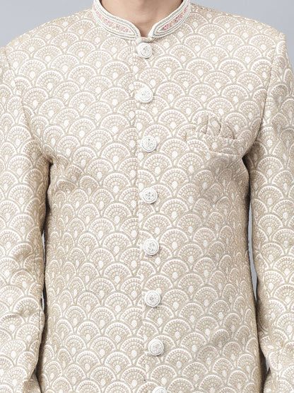 Men's light brown sherwani with intricate white embroidered geometric pattern, mandarin collar, and matching white churidar pants - ideal for special occasions and weddings