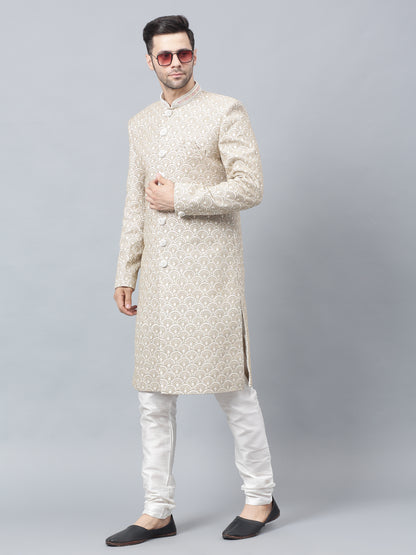 Men's light brown sherwani with intricate white embroidered geometric pattern, mandarin collar, and matching white churidar pants - ideal for special occasions and weddings
