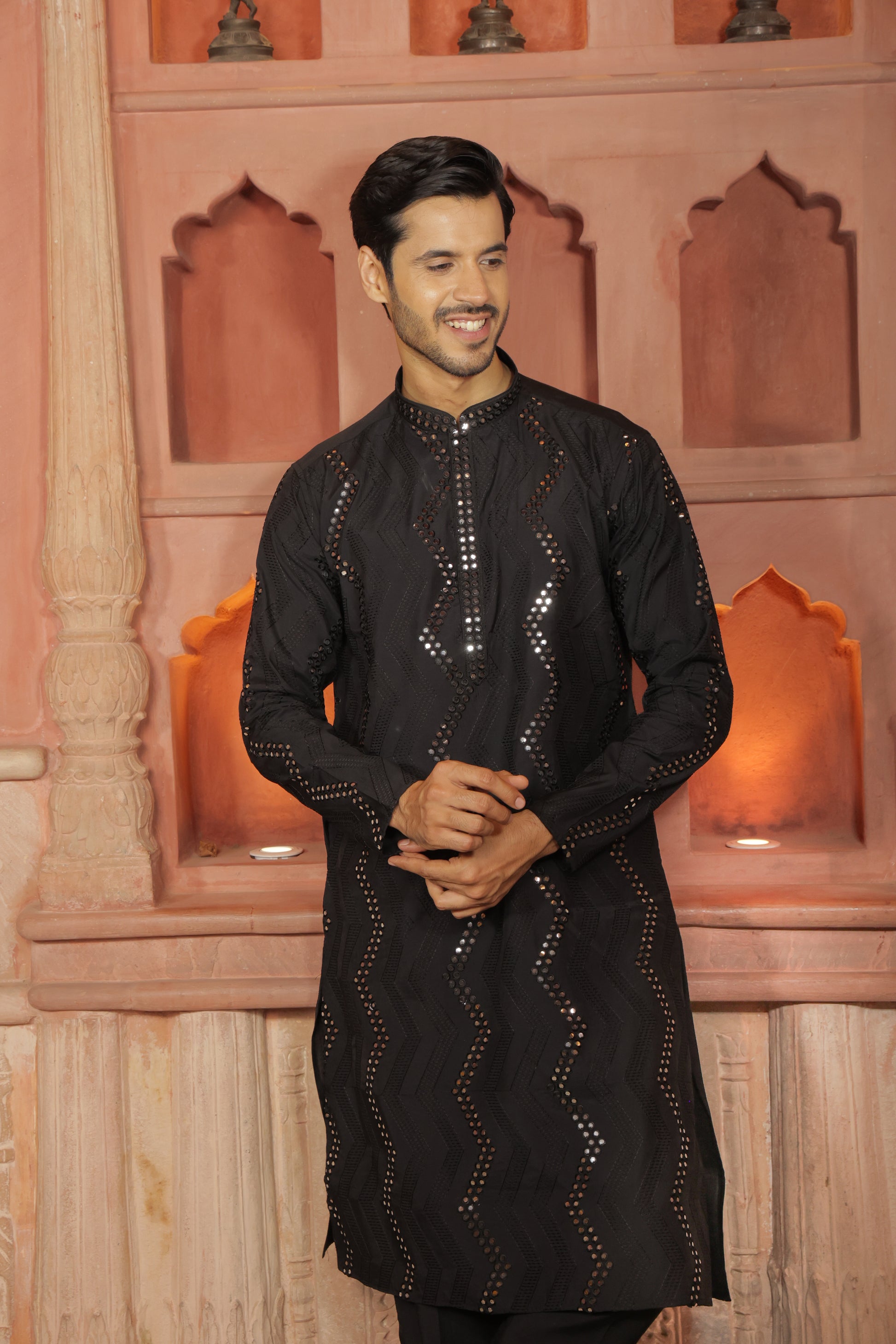 Men black embroidered kurta with intricate thread and mirror work paired with black pajama, mandarin collar, button closure, covered placket, traditional Indian ethnic wear set for festive and wedding occasions, formal wear for special occasions