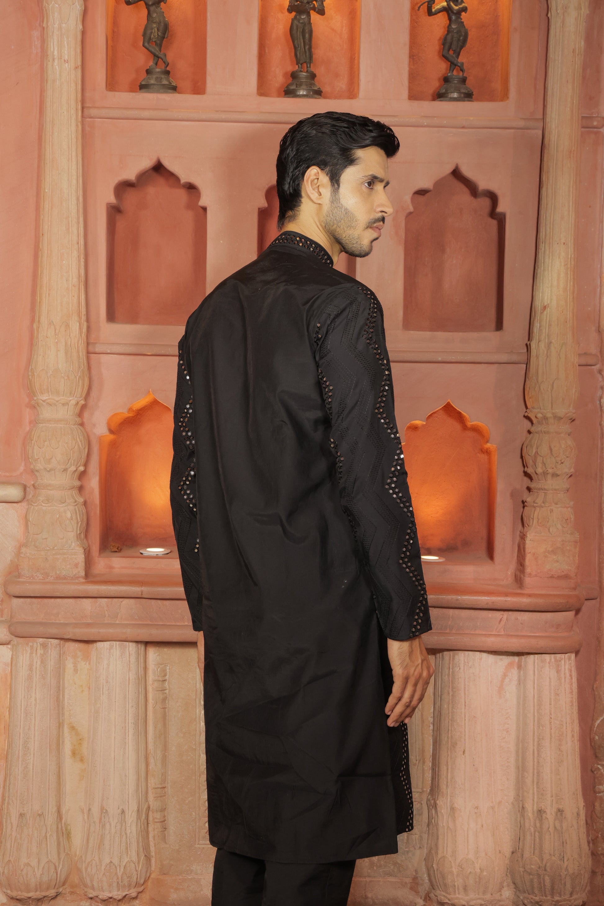 Men black embroidered kurta with intricate thread and mirror work paired with black pajama, mandarin collar, button closure, covered placket, traditional Indian ethnic wear set for festive and wedding occasions, formal wear for special occasions
