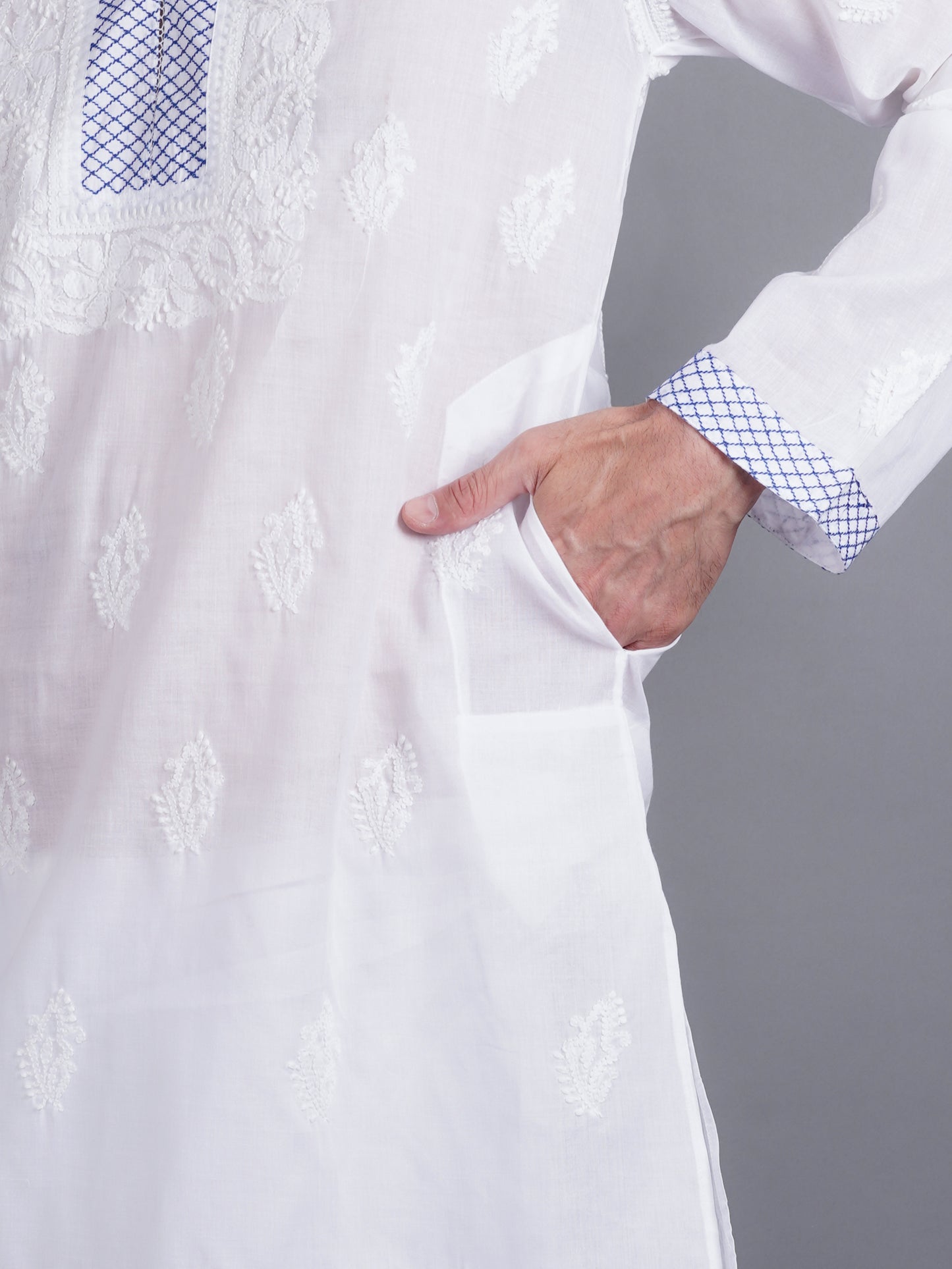 Men White chikankari Kurta  made of pure white Linen, full length, button closure, blue thread work on placket, full sleeves, mandarin collar, side pockets, traditional wear for family occasions, casual wear