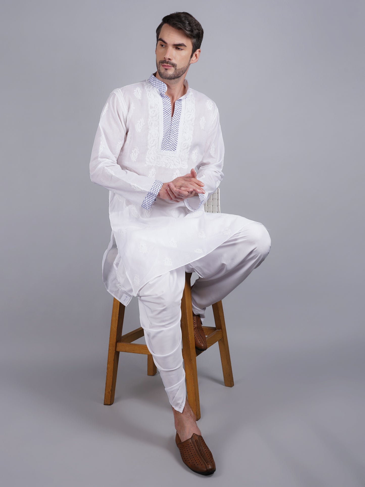 Men White chikankari Kurta  made of pure white Linen, full length, button closure, blue thread work on placket, full sleeves, mandarin collar, side pockets, traditional wear for family occasions, casual wear